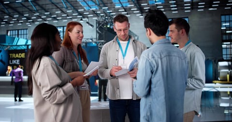 Man presenting new technology to diverse group in convention hall